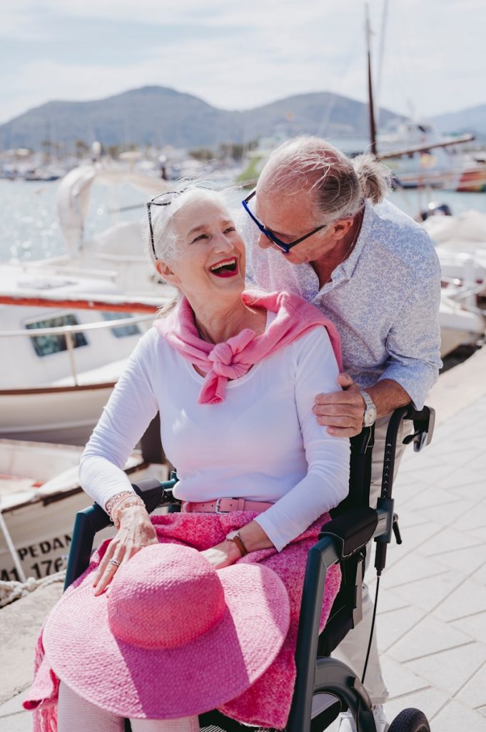 a man and a woman sitting in a wheel chair